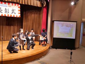 館長賞の美南小学校3年生の馬場音羽さんの絵を表彰式会場でスクリーンに映し出す場面
