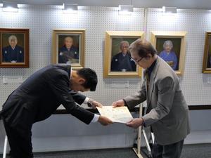 篠田先生に頭を深々と下げて感謝状を贈呈する市長