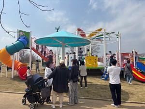 インクルーシブ遊具の周りに集まる人々