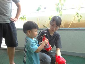 消火器の水鉄砲で遊ぶ親子の写真