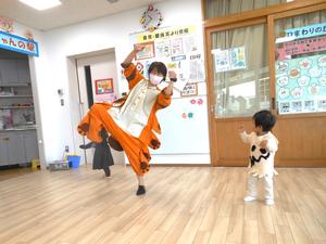 猫バスに仮装している保育士とおばけの仮装をしている男の子が踊っている様子