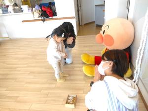 アンパンマン神社で「なんまいなんまい」と手を合わせる親子の様子