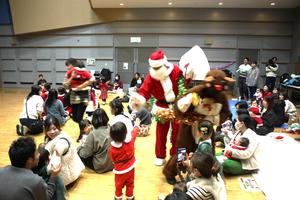 サンタクロースとハイタッチをする子どもの様子