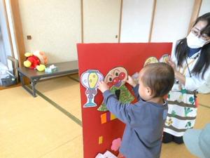 ゲームでアンパンマンの顔パネルを貼りつけている男の子の様子