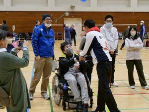 チームメイトと握手する市長