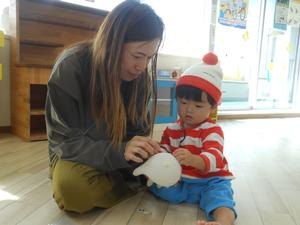 ママと一緒にゴム手袋おばけを作るウォーリーに仮装した男の子の写真